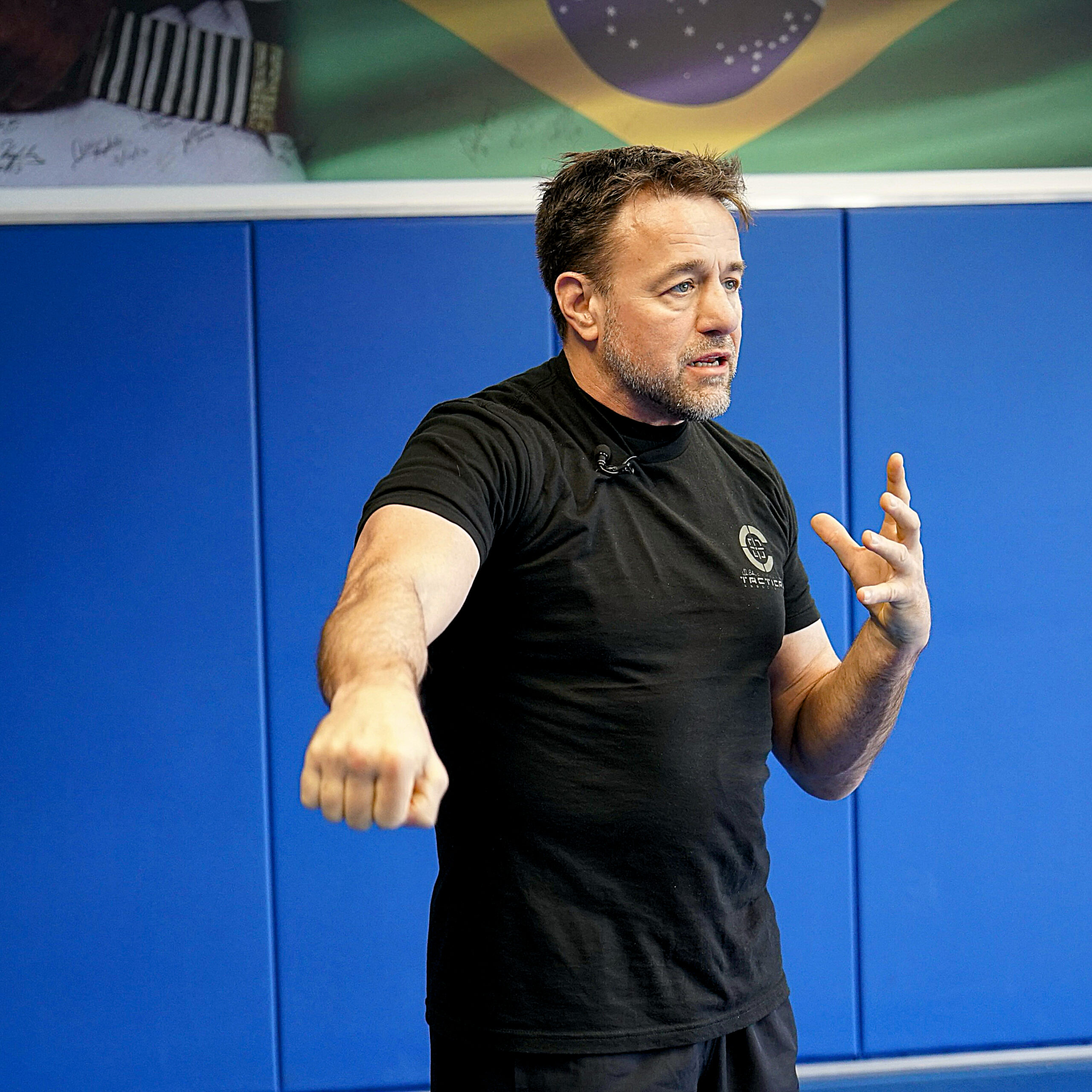 Alan Baker teaching in front of a blue padded training wall
