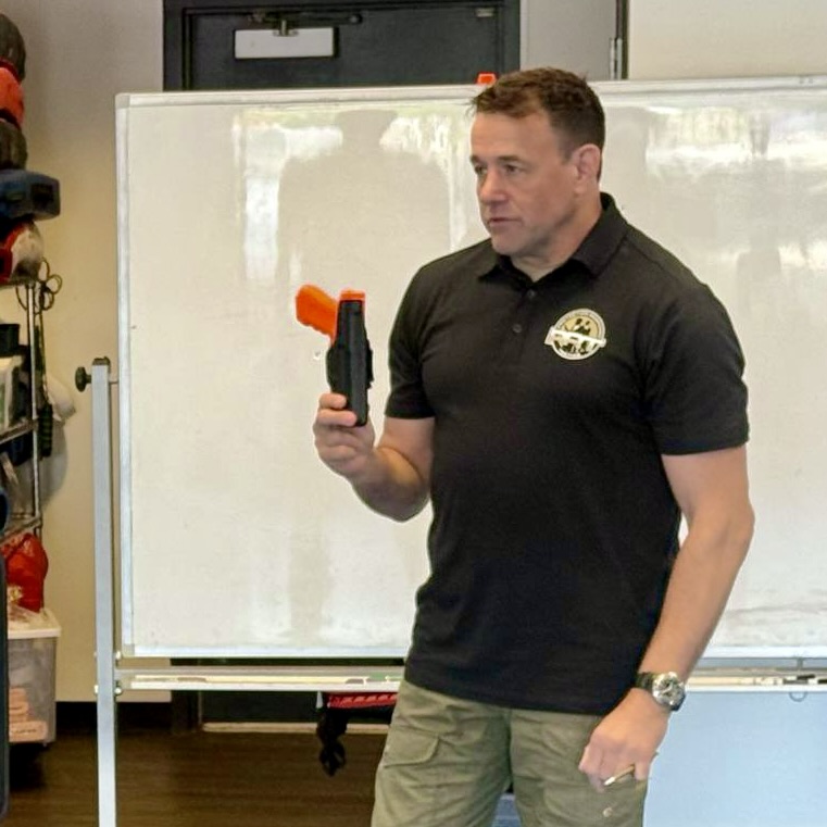 Sifu Alan baker teaching about adding the firearm into you training using a training kit 