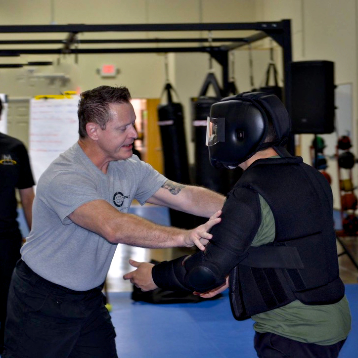 Coach Chris Myers working on a body armor drill with one of the other instructors at a C-Tac training camp in Atlanta, Georgia