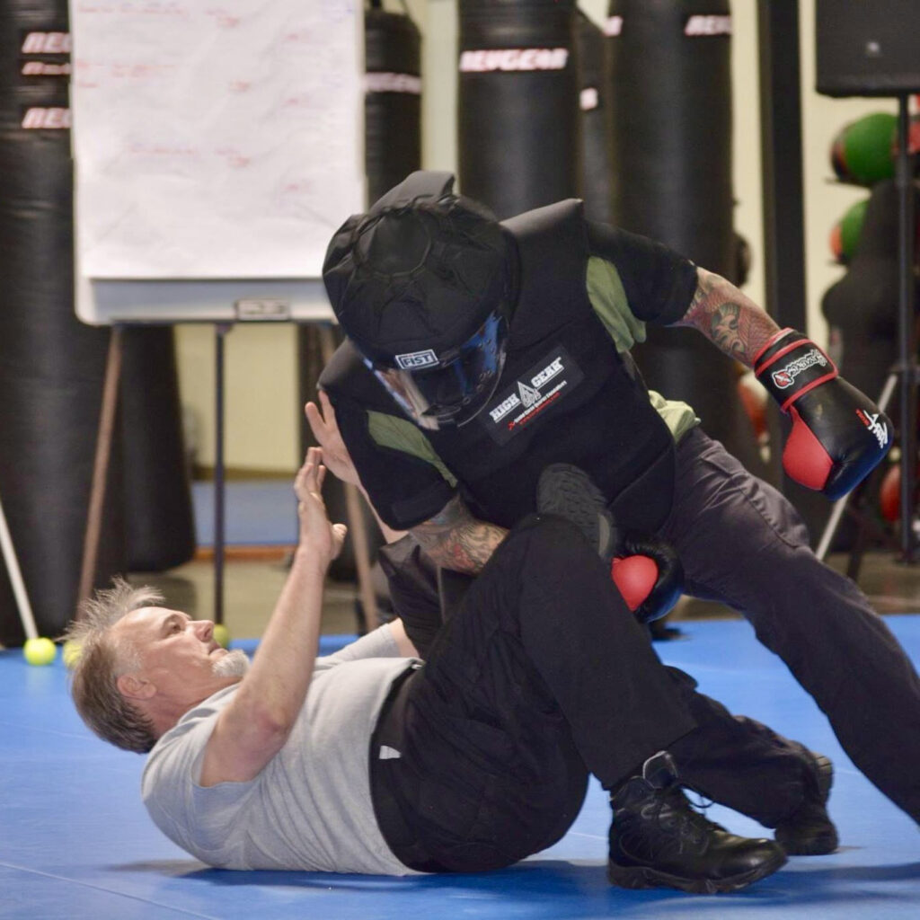 Two of the C-Tac instructors engaging in a body armor drill on the ground at one of the instructor training events in Atlanta, Georgia