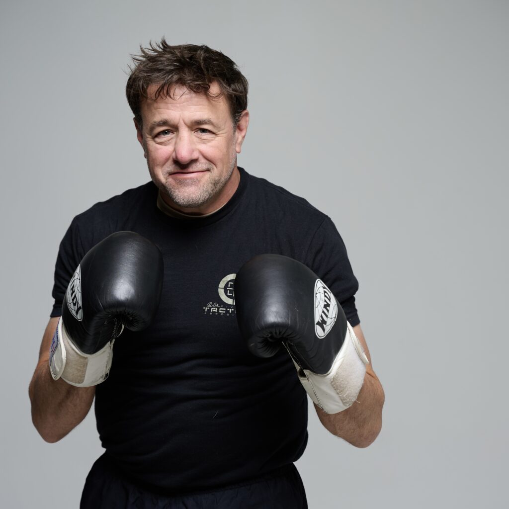 Sifu Alan Baker with a set of boxing gloves on