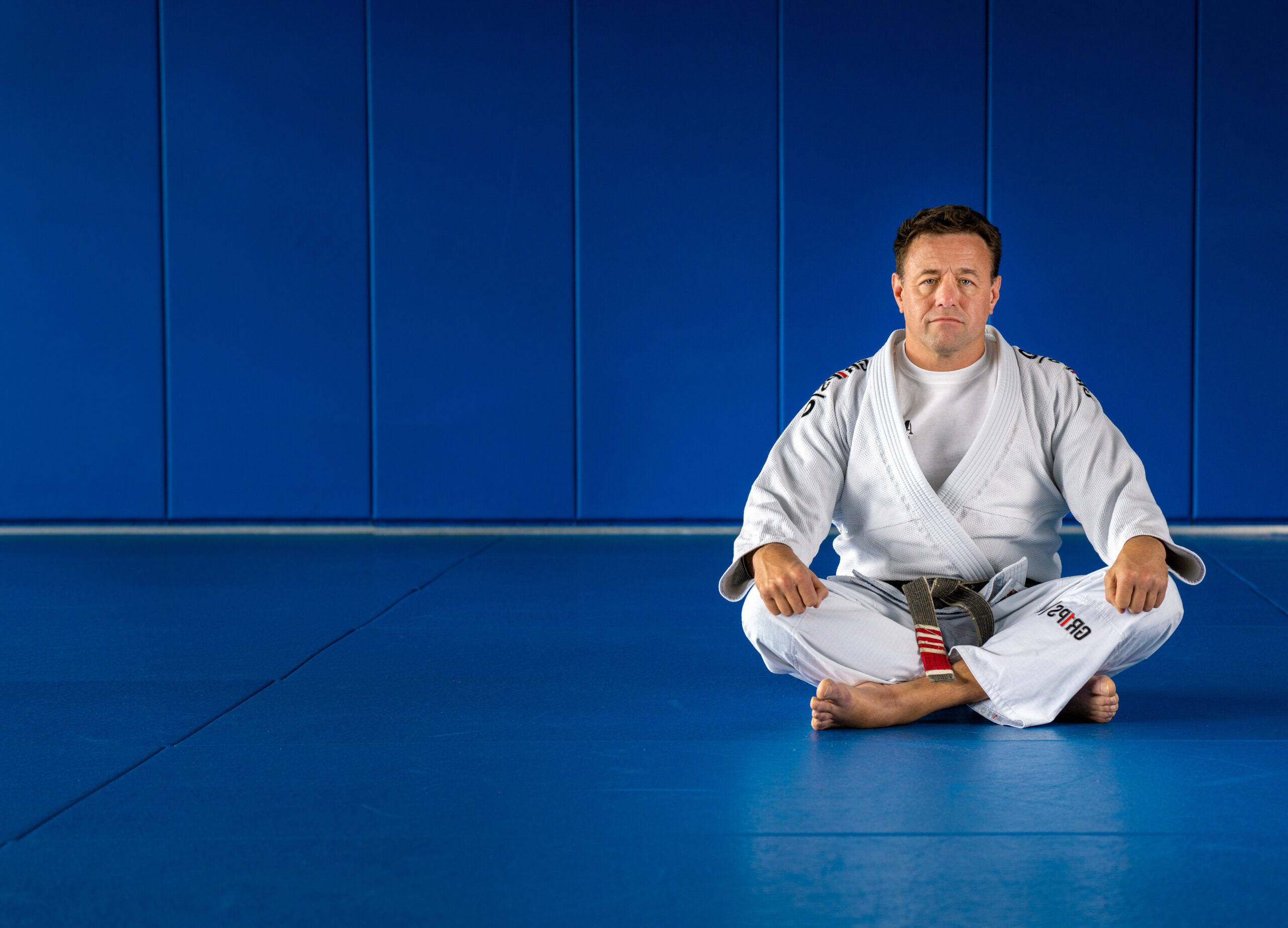 Alan Baker seated in Brazilian Jiu-Jitsu gi