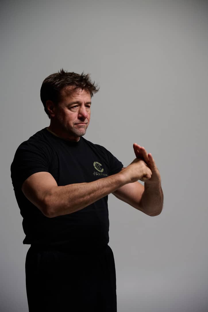 Alan Baker seated cross-legged in a Brazilian Jiu-Jitsu gi