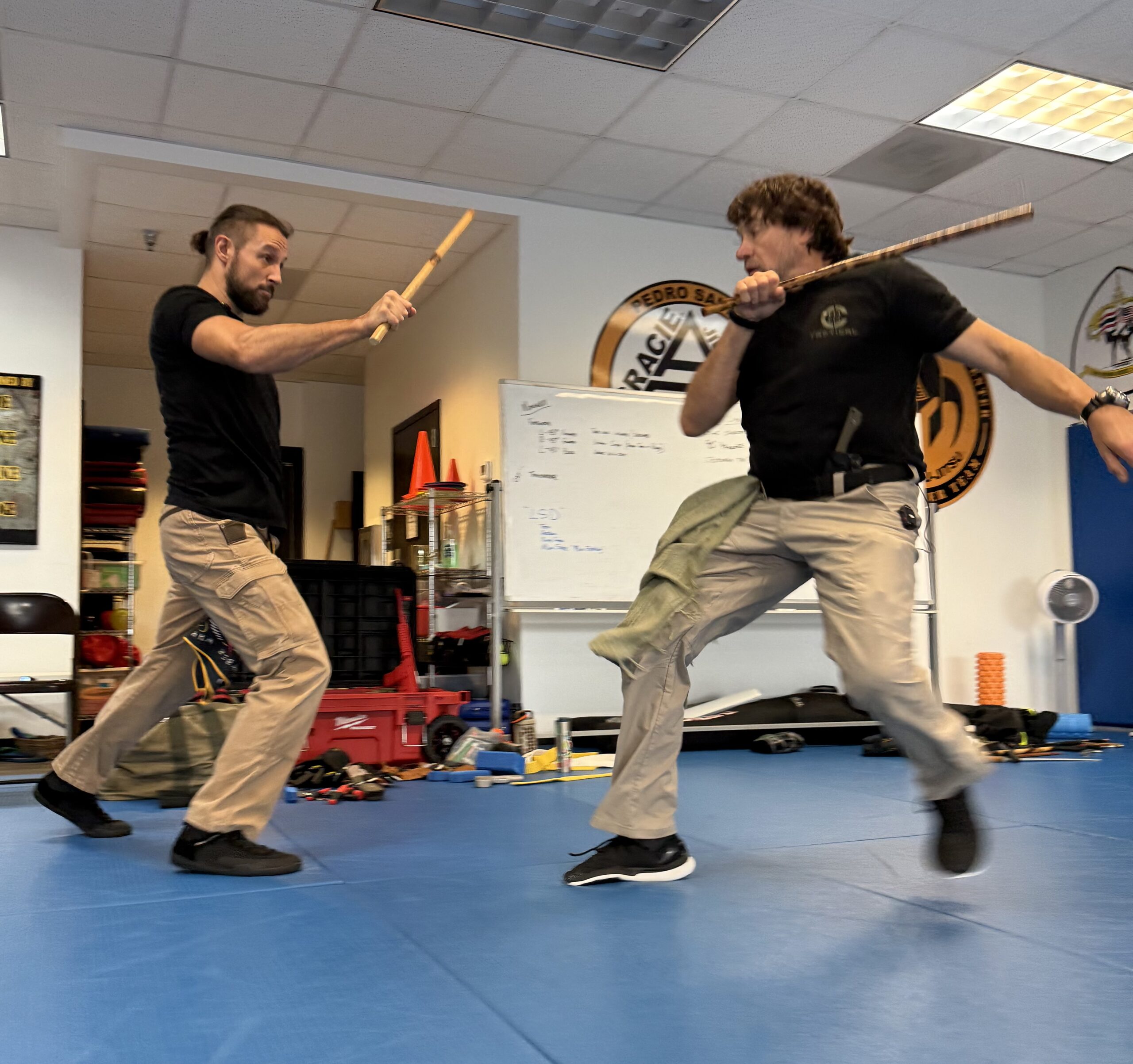 C-TAC instructors participating in controlled impact-weapon sparring