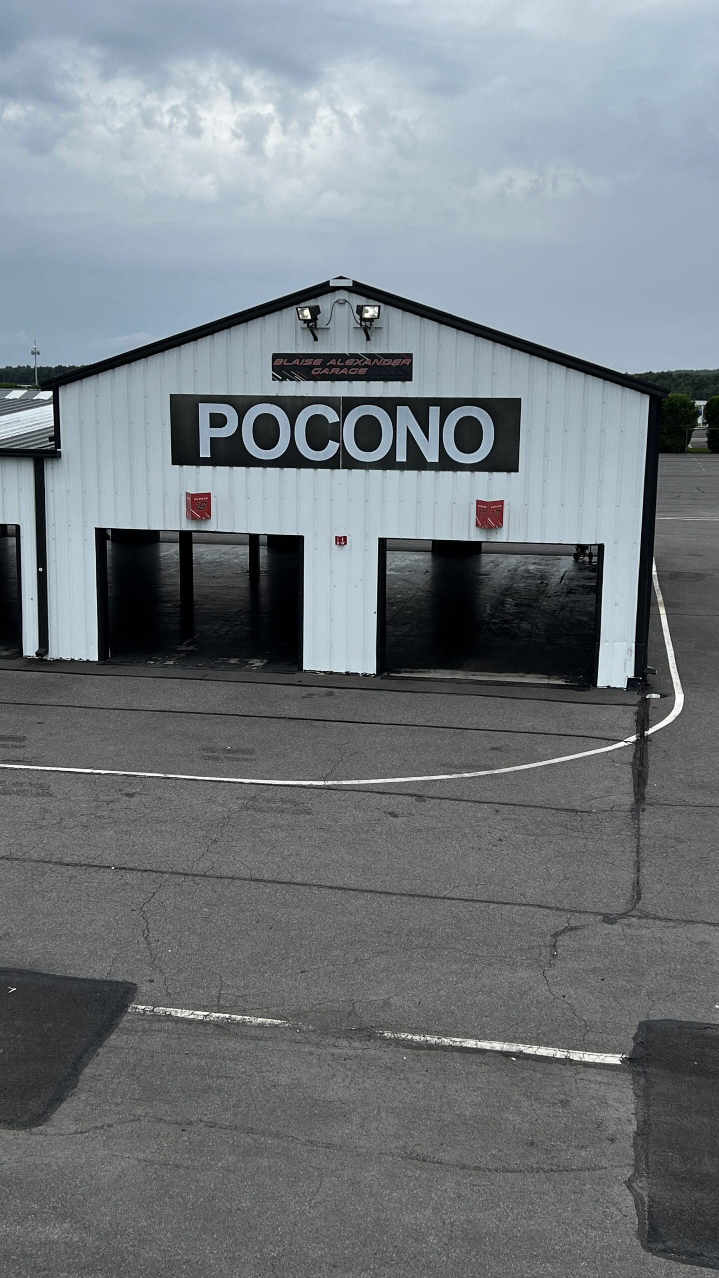 Pocono Raceway training garage beneath an overcast sky.