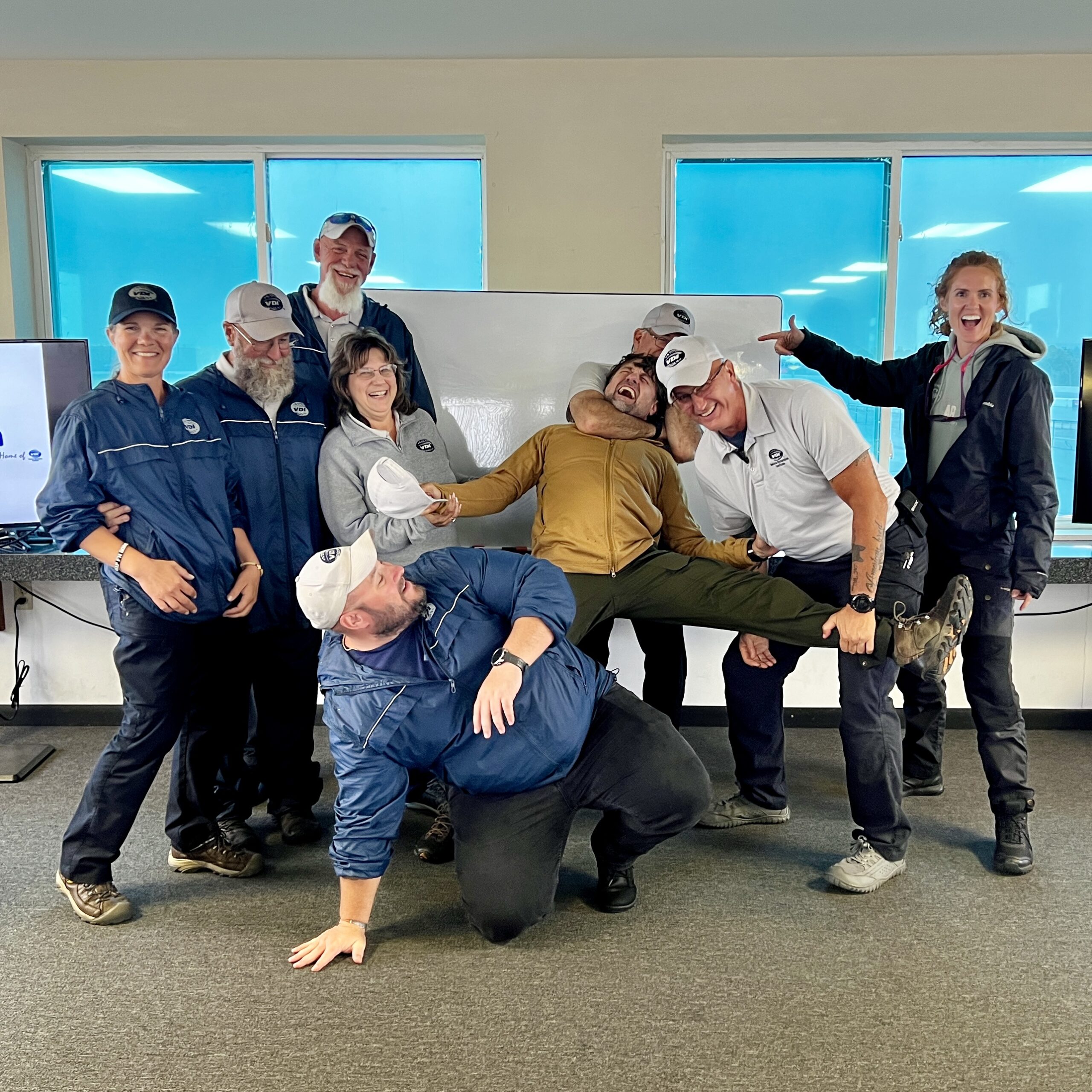 Alan Baker and the Vehicle Dynamics Institute team sharing a lighthearted moment after training.