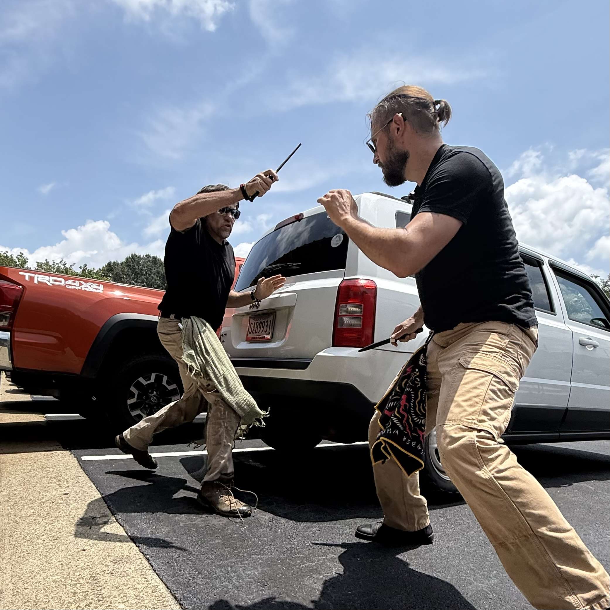 C Tac students training defensive tactics around a vehicle