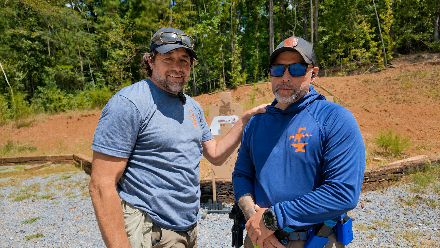 Alan Baker and Coach Dennis during a monthly firearms training session at an outdoor range.