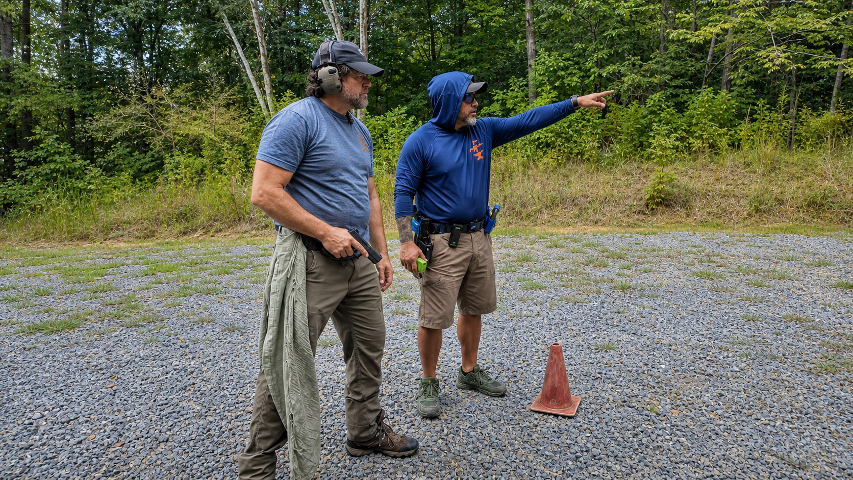 Coach Dennis discusses the next firearms drill with Alan Baker during their monthly range training.