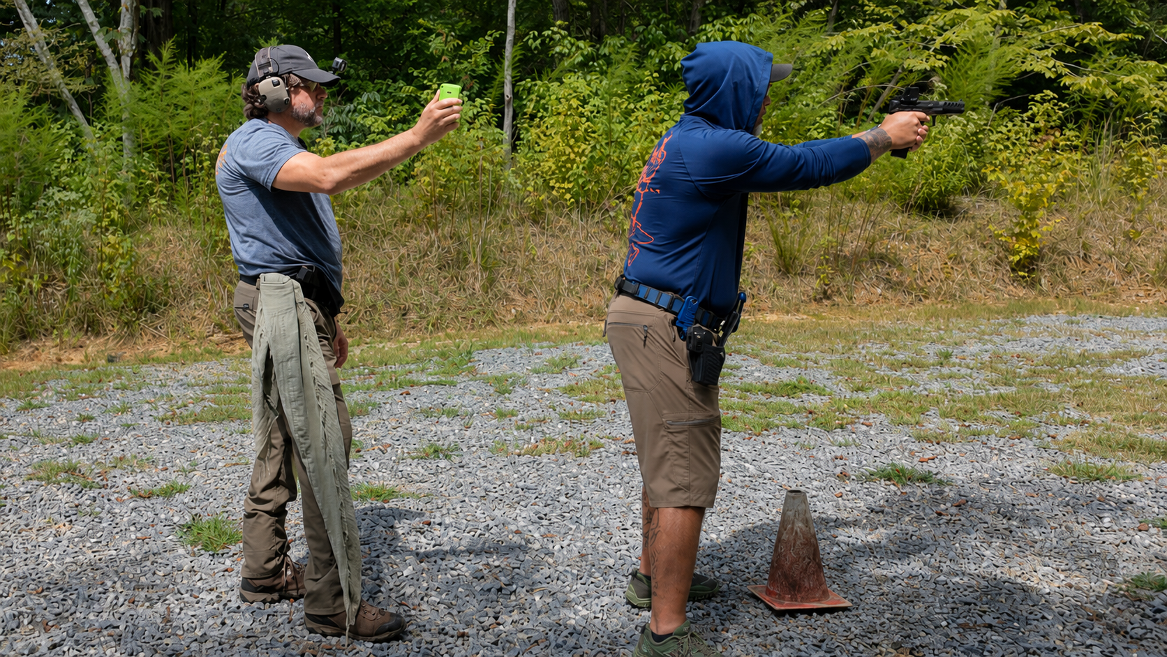 Coach Dennis conducts live-fire practice while Alan Baker records feedback during a monthly range session.