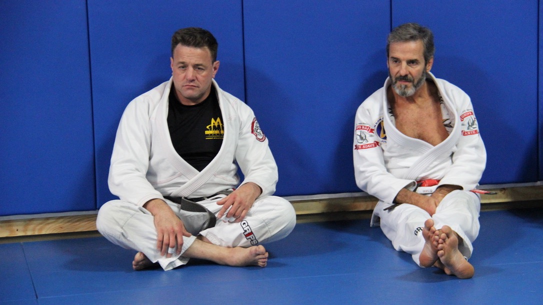 Alan Baker seated with Master Pedro Sauer during an earlier Jiu-Jitsu training event.